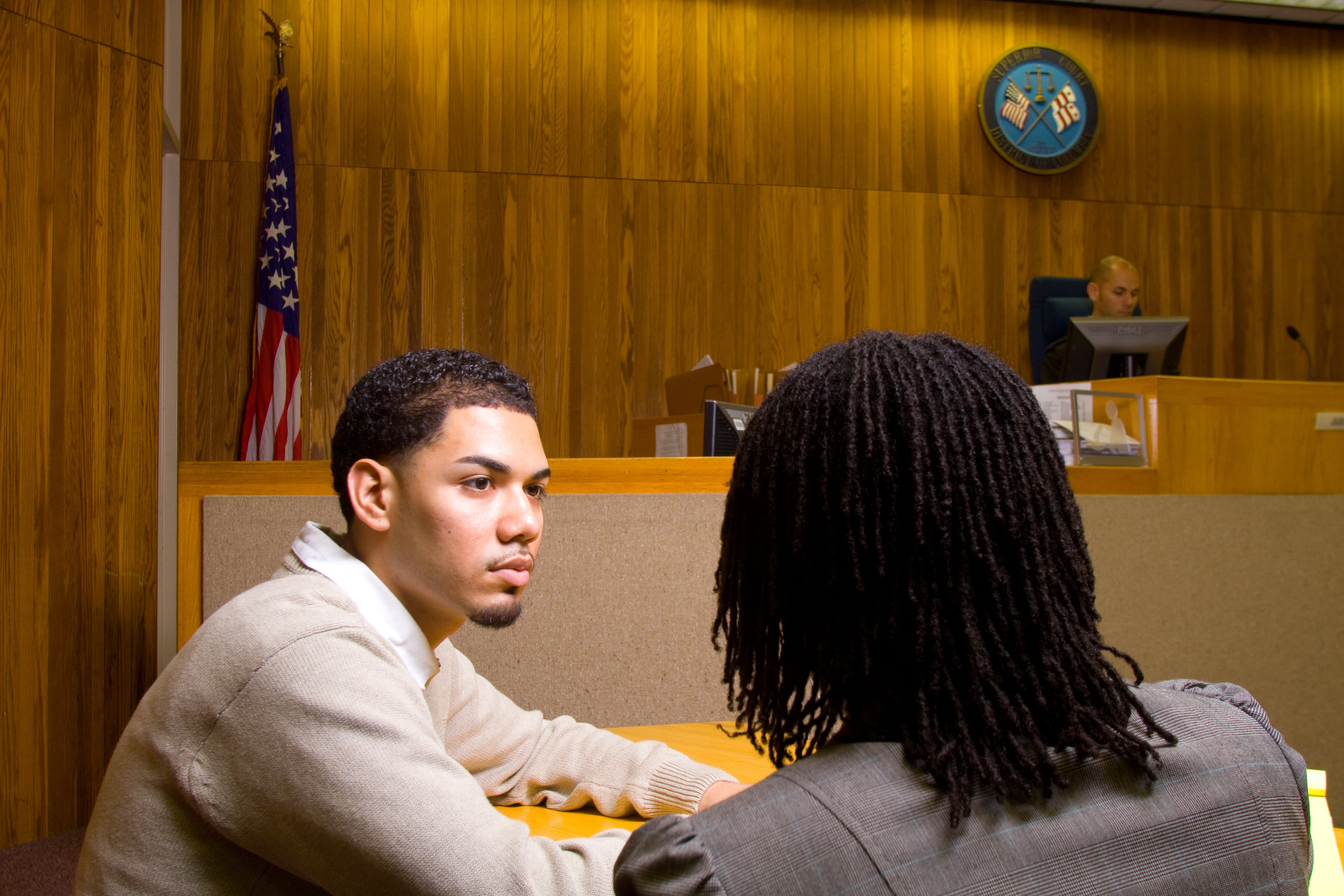A staged courtroom scene of a lawyer representing a client.