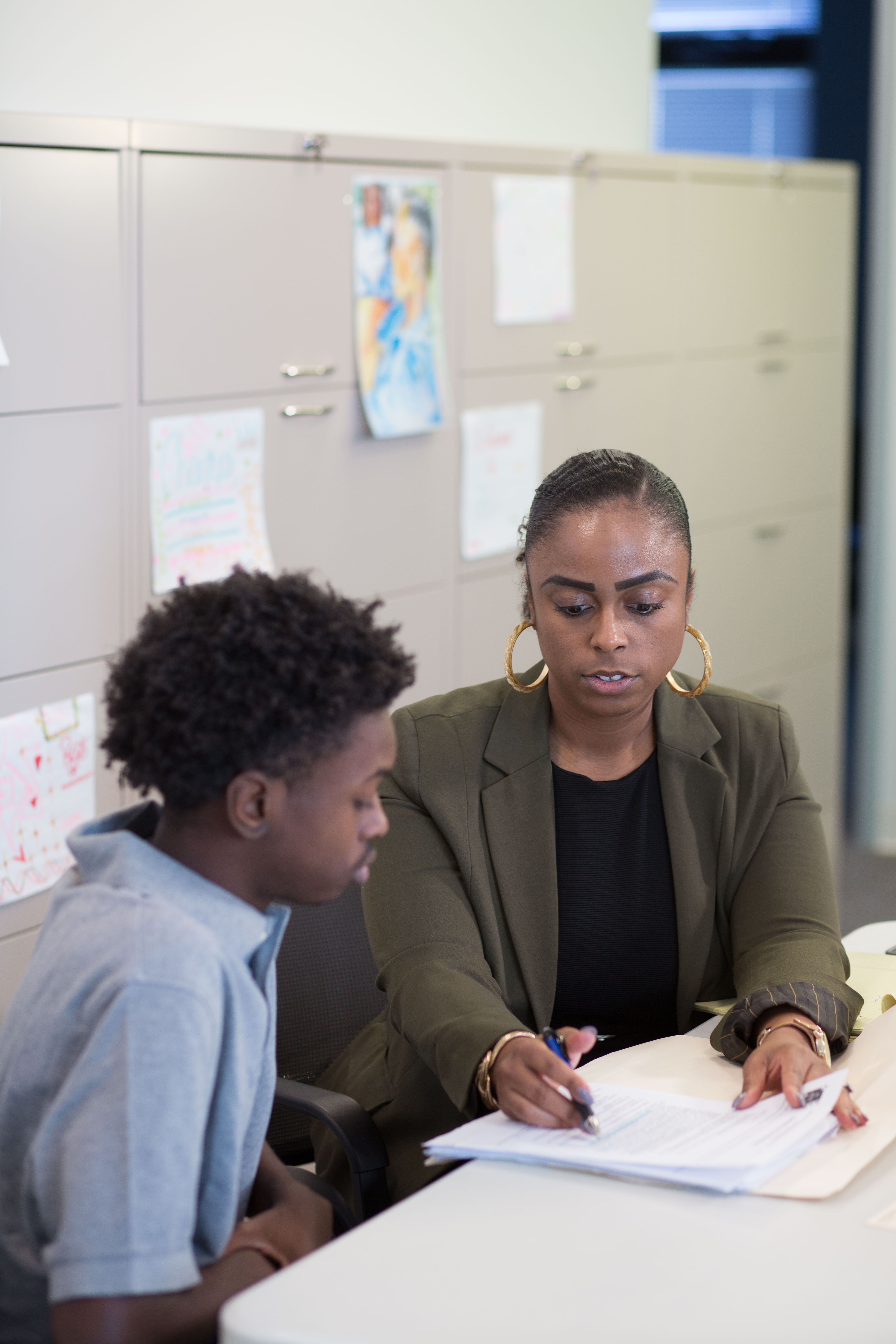 Lawyer reviewing documents with a young person.